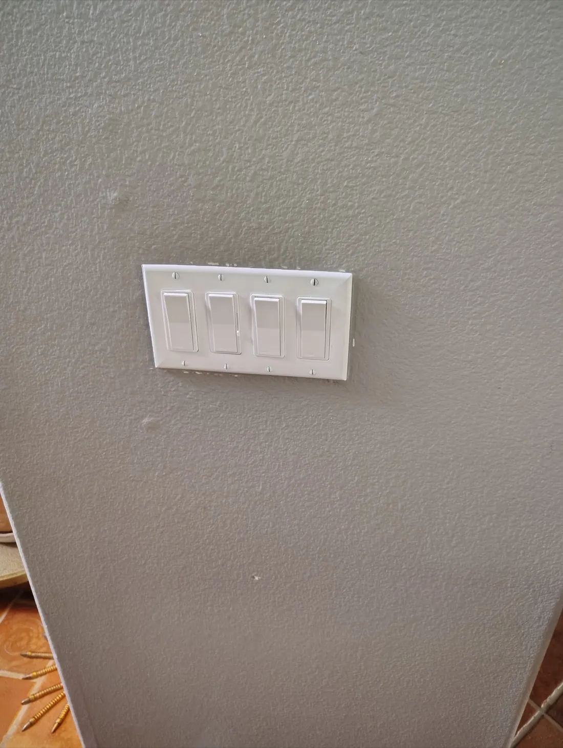 Four-gang light switch plate professionally installed on textured drywall — Zomg The Handyman