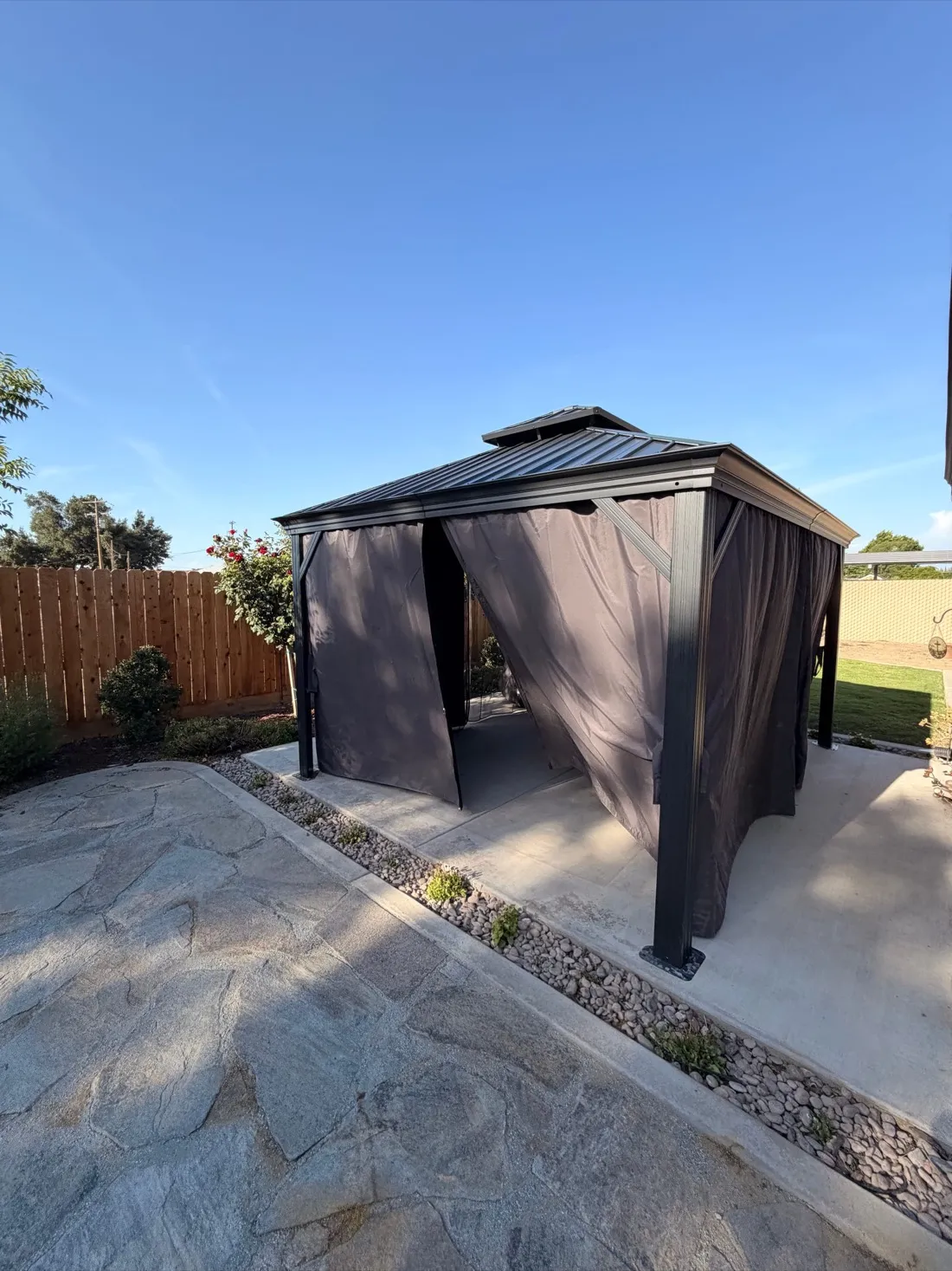 Modern pergola with integrated shade curtains installed on concrete patio — Zomg The Handyman