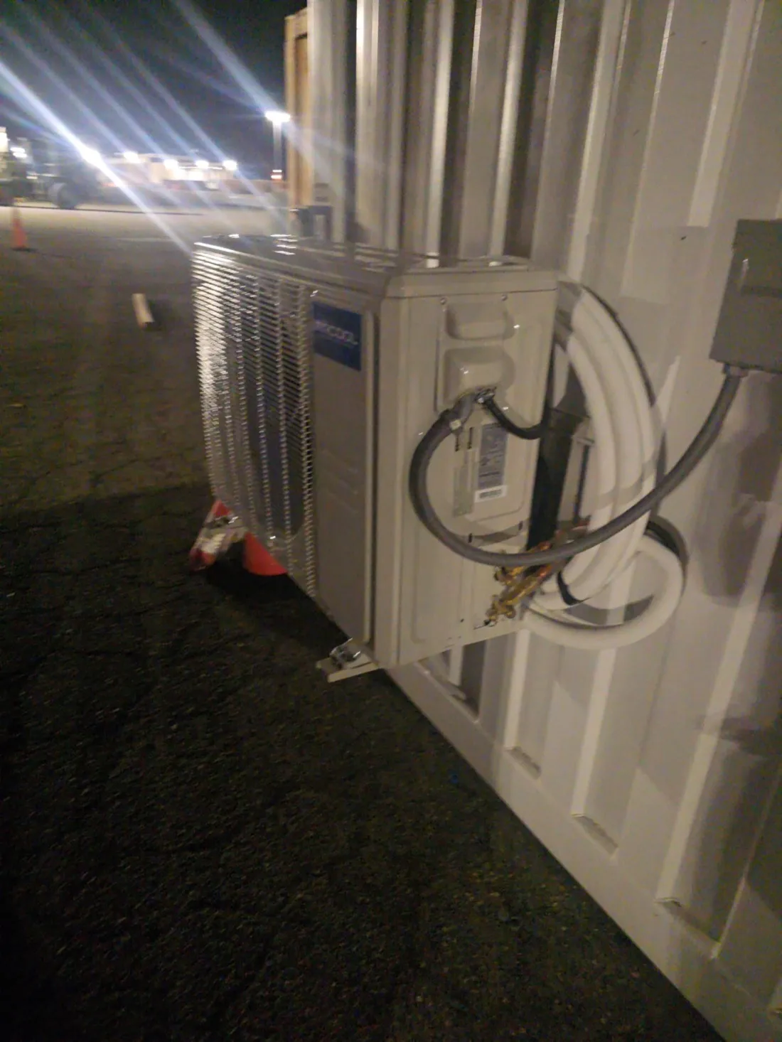 Outdoor mini-split AC unit installed with properly connected refrigerant and electrical lines — Zomg The Handyman