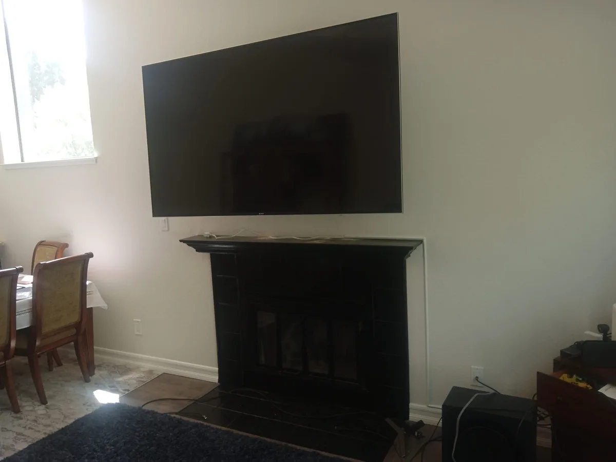 TV mounted over a fireplace with fully concealed cables by Zomg The Handyman near Bodega Bay, CA