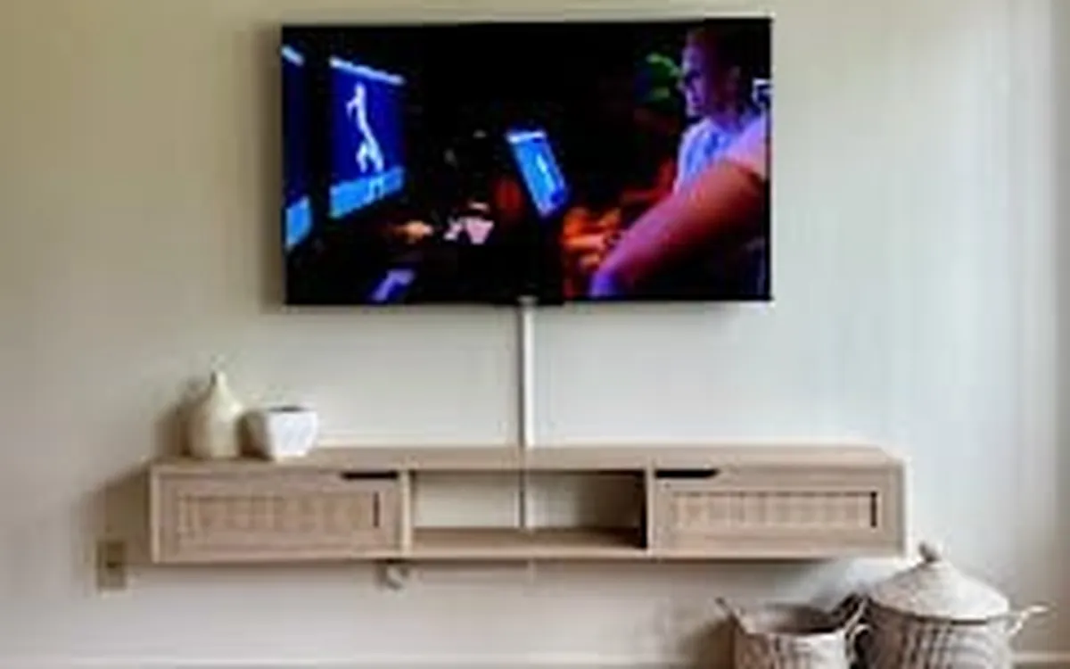 TV mounted above a media console, cables hidden