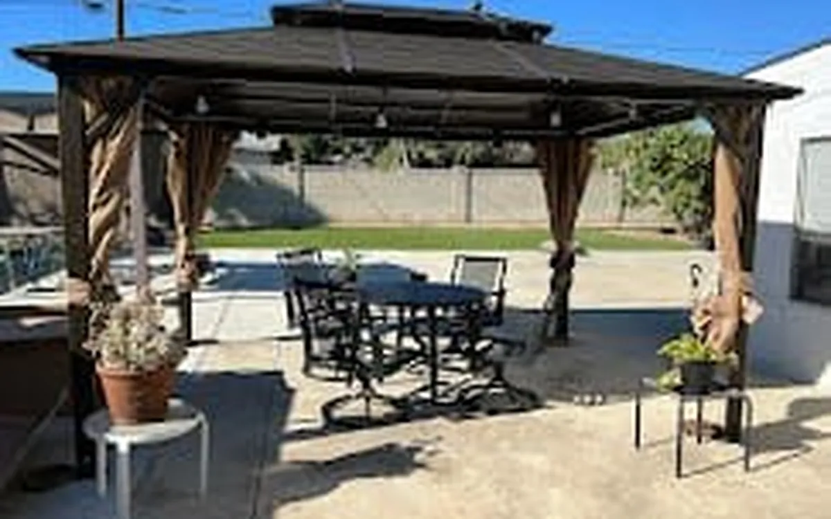 Dark aluminum hardtop gazebo with patio furniture, assembled by Zomg