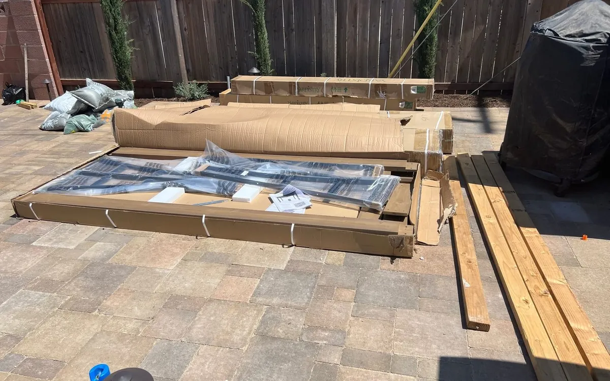 Gazebo parts laid out on the patio before assembly