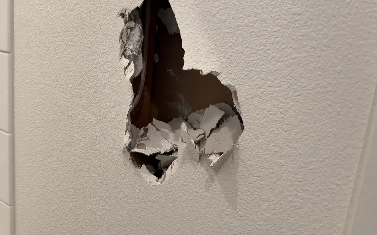 Drywall hole before patching