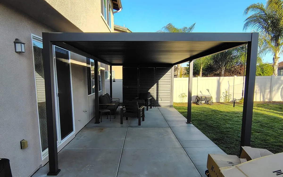 Black aluminum pergola on a concrete patio