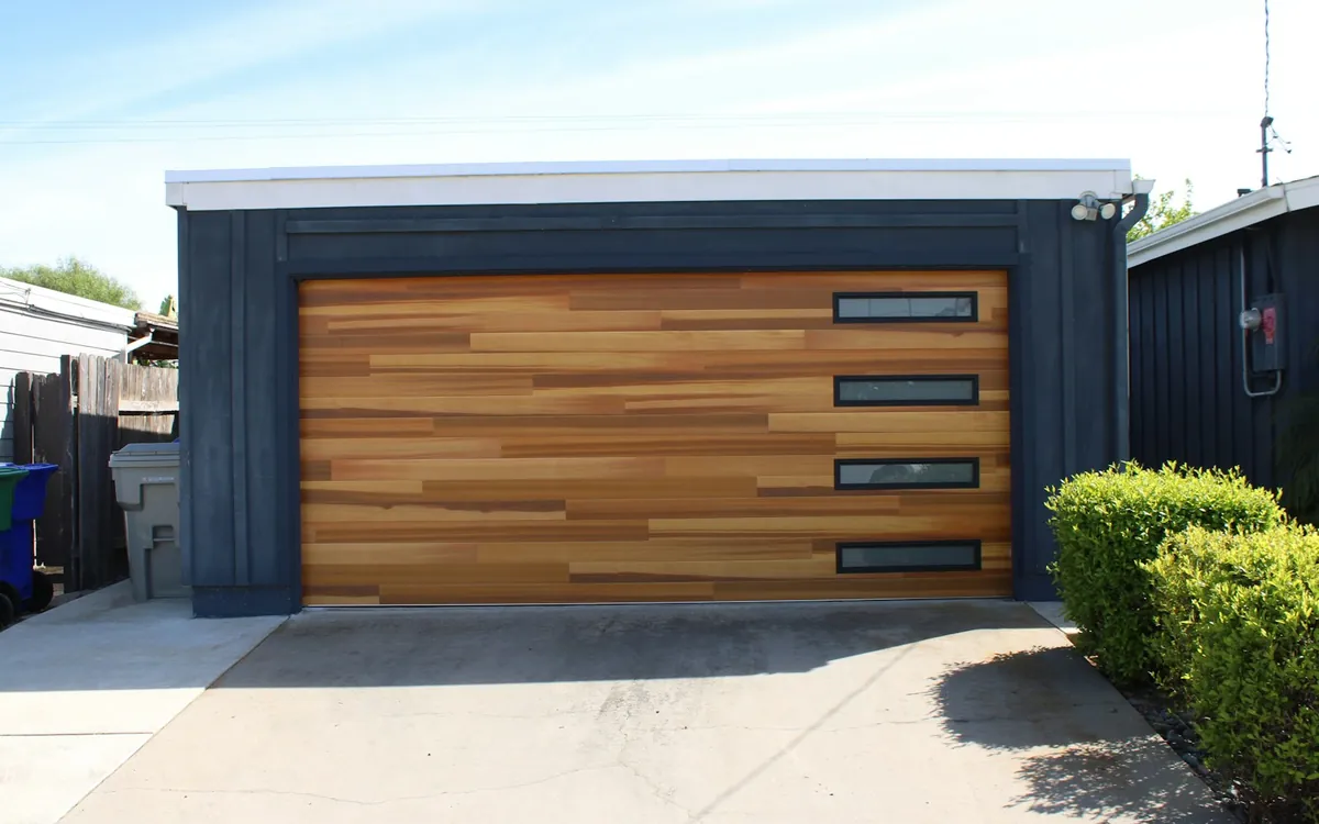 Garage door with wood panels and windows