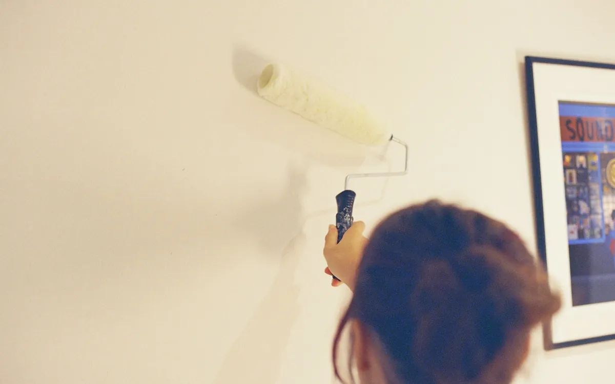 Painting a pale wall with a roller