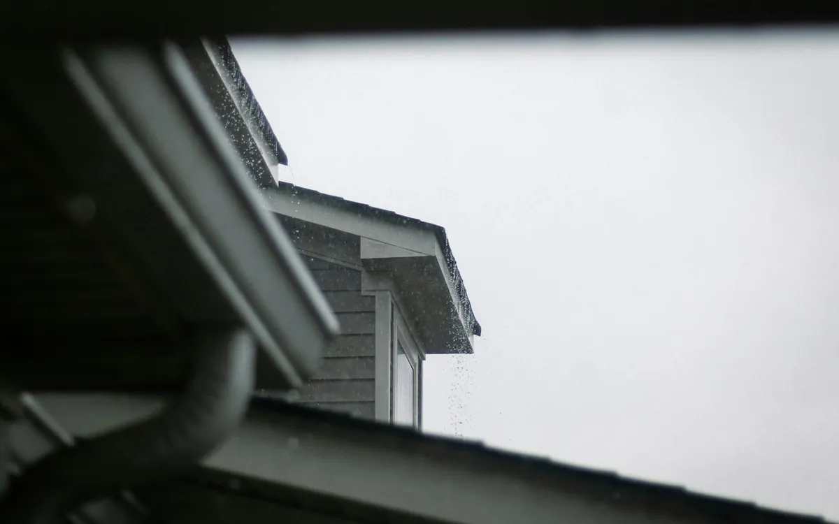 Roof and gutter system against the sky