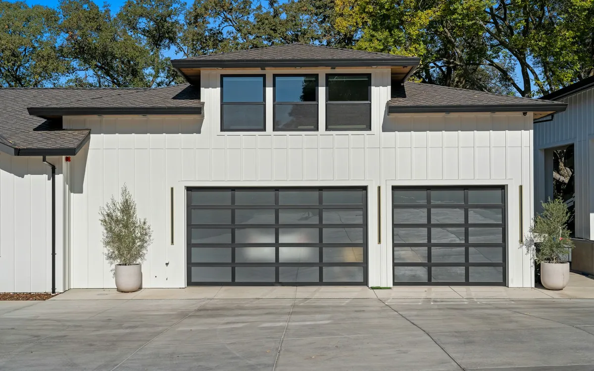 Modern garage doors on a white house