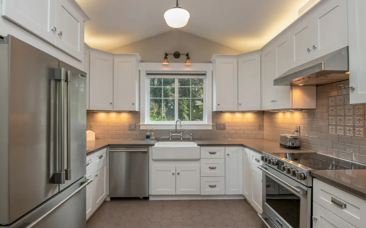 Kitchen with lit cabinets and pendants