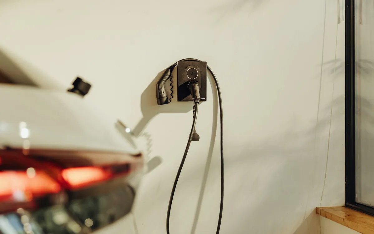 Electric car plugged into a wall charger