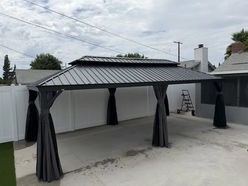 Hardtop gazebo assembled on a backyard patio by Zomg The Handyman